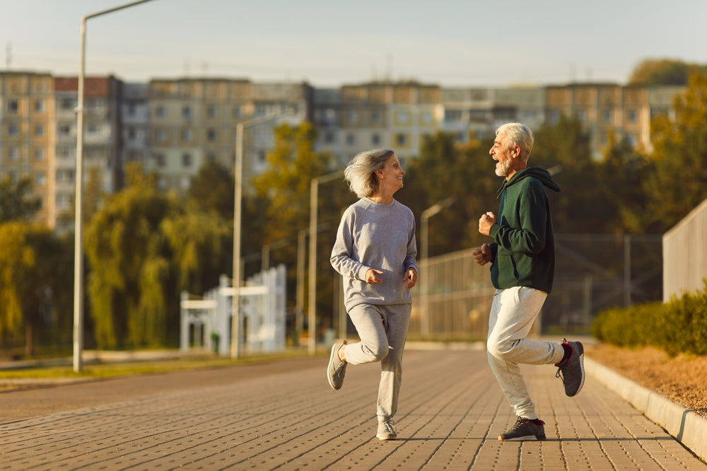 Two older people running